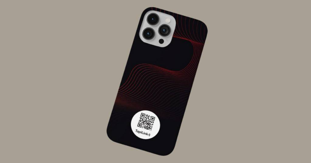 Close-up of an iPhone with a custom NFC business card design, featuring a QR code on the back of the phone.