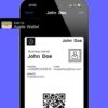 A digital business card displayed on an iPhone within the Apple Wallet app interface, held by a person in a business suit, emphasizing a modern and professional networking tool.